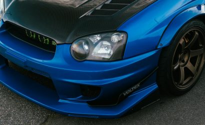 blue subaru sti with carbon fiber hood